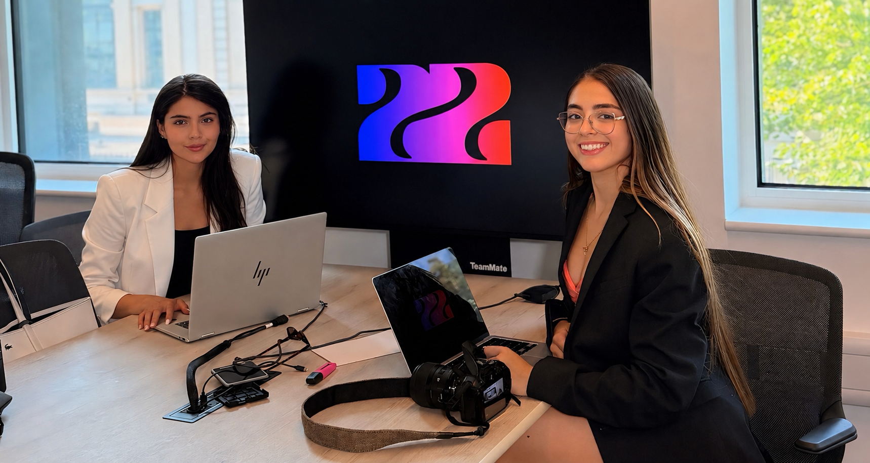 The NOVA22 founders working together at a desk in front of the NOVA22 logo